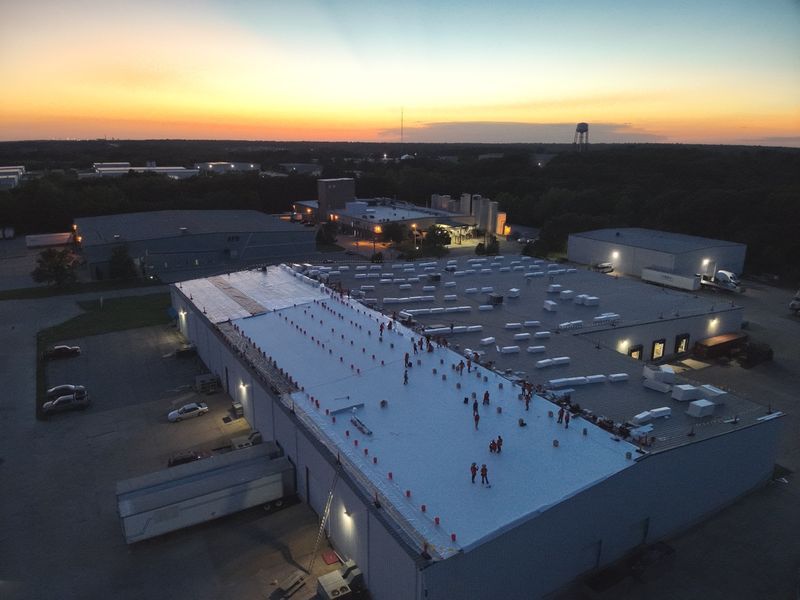 Large industrial roof under maintenance with the Amigo crew