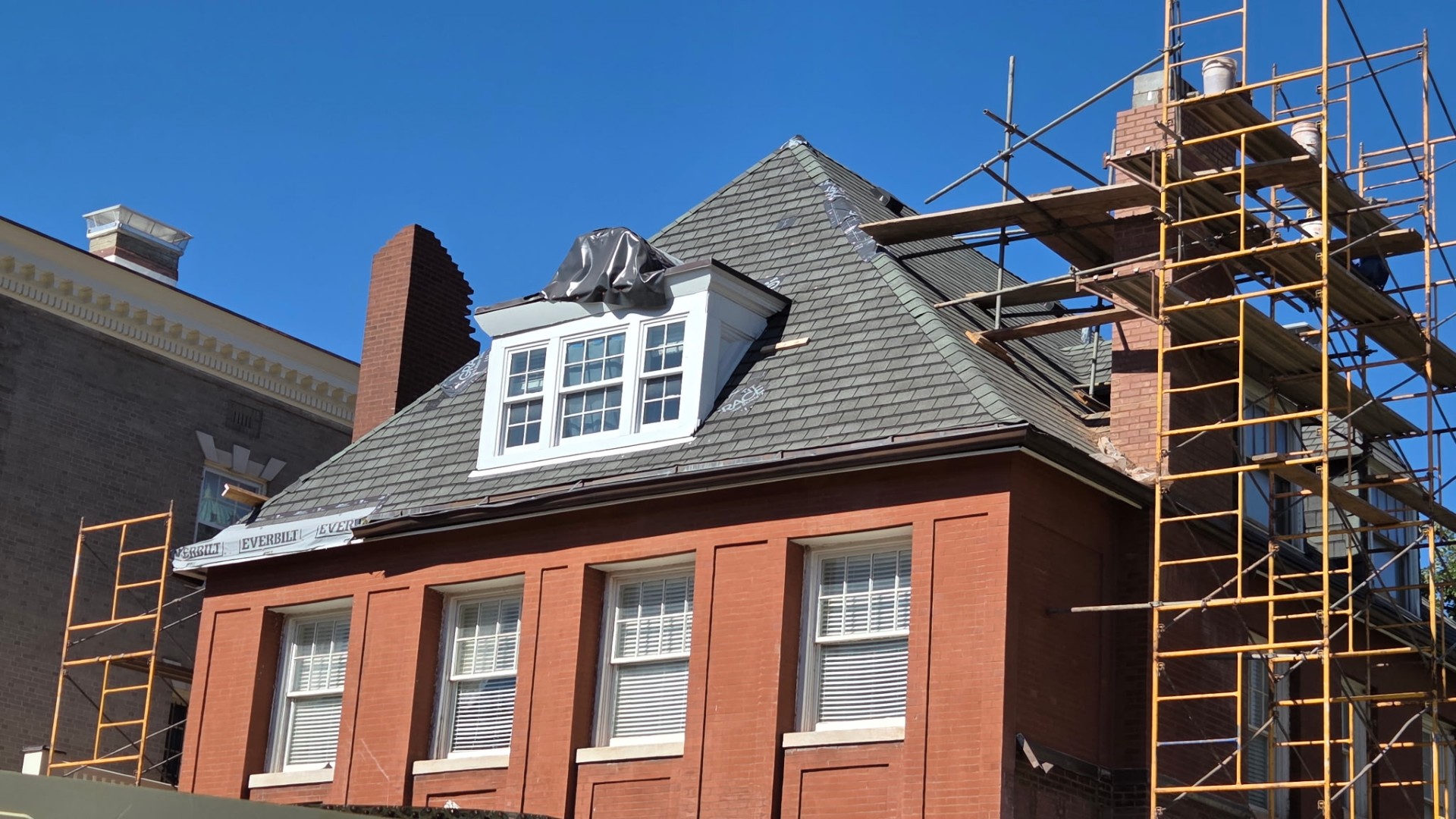 Amigo masonry restoration project on a historic brick building with full scaffolding